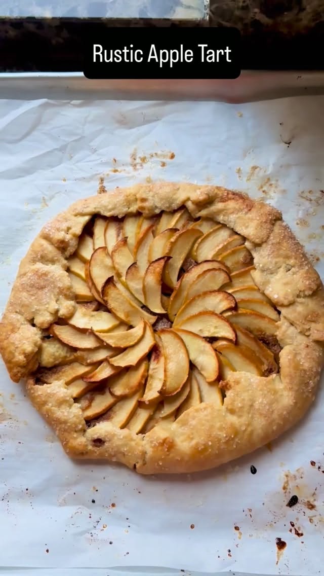 Move over apple pie - this simple, rustic apple tart takes only a few minutes to prepare and is the perfect Fall dessert. The full recipe is in the caption, follow @dinnerreinvented for more simple and delicious meals you can make at@home! #fallbaking #fallrecipes #applepie #dinnerreinvented #autumnvibes 

Apple Tart
Pie Crust:
1 cup flour
1/2 tsp salt
1 stick of butter 
3 tbsp ice water

using a standing mixer, combine the flour in the salt and turn on low speed. Cube the cold butter into tiny pieces and add a little at a time until welcome combined. Add in a tablespoon of ice water at a time until a dough forms. Form into a circular disc, wrap in plastic wrap, and refrigerate while you make the filling.

Filling:
3-4 apples (I used Fuji)
2 tbsp sugar
Juice of half a lemon

Jam of choice, two tbsp butter and sparkling sugar 

To Assemble:
slice the apples into very thin strips, place in a bowl and add sugar and lemon juice and give it a toss. Place the disc of dough on a parchment lined baking sheet, roll out until you have a thin circular layer. Scoop a few tablespoons of the jam into the center of the dough and spread a thin layer, but do not reach the edges. Starting from the lower fourth of the dough, begin fanning the apples, overlapping them slightly until you reach the center of the dough. Fold over the edges of the dough and crimp any edges so the sugar and filling don’t burn when you bake it. Top with a couple dots of cold butter and sparkling sugar over the entire tart, especially the crust. Bake at 350° for 20 to 30 minutes or until the crust is lightly brown.